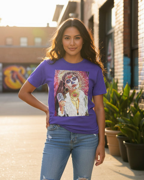 Woman wearing a purple t-shirt with a colorful graphic design, standing outdoors.